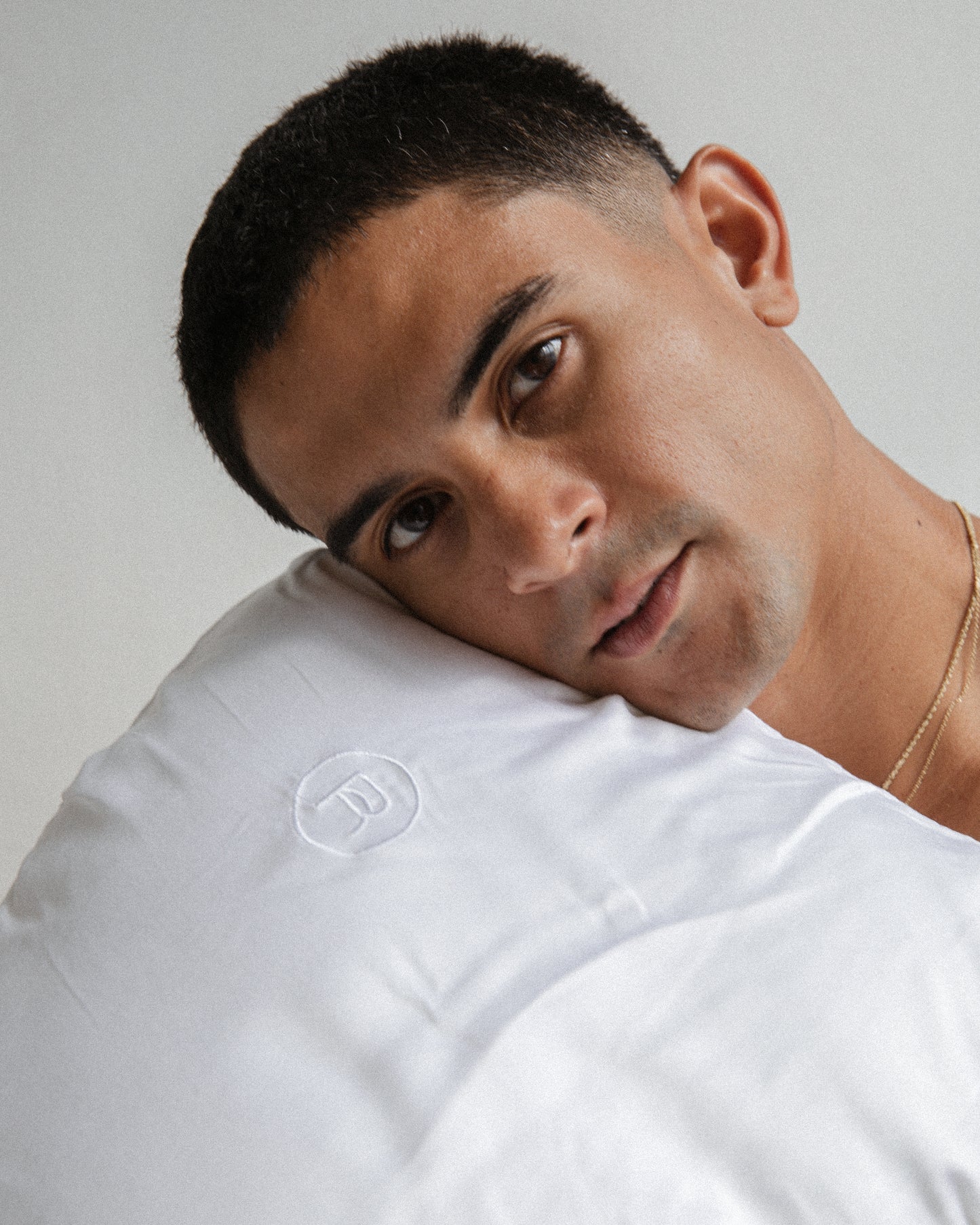Male Model Leaning on White Bamboo Pillowcase